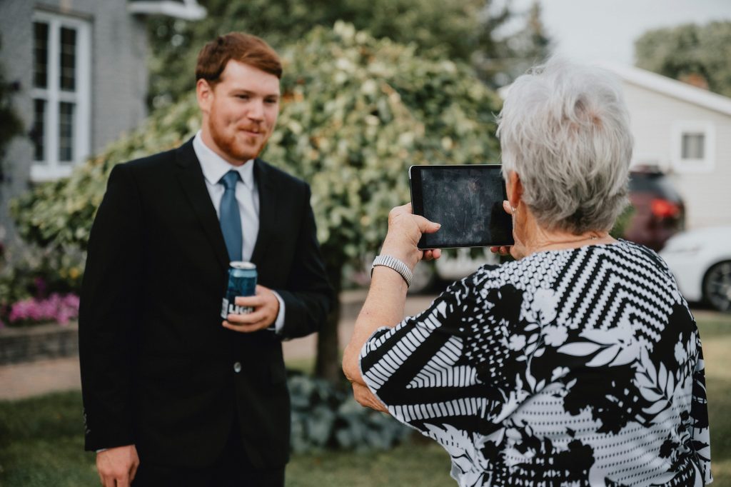 North Gower Backyard Wedding - grandma takes a picture of the groom
