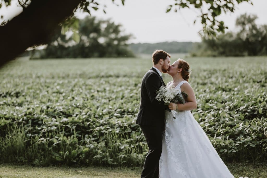 North Gower Backyard Wedding - bride and groom kiss in the backyard