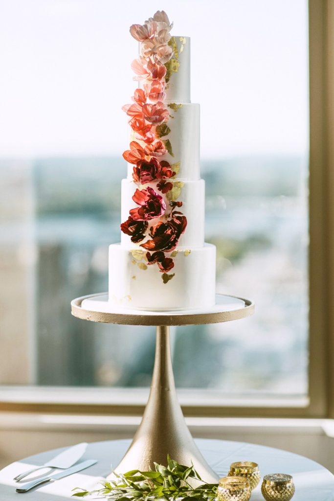 Gorgeous Four-Tier White Cake with Gold Flakes. Photo by Cindy Lottes Photography