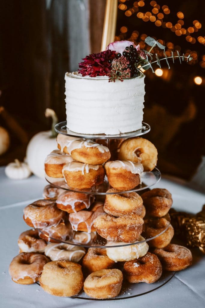Donut Tower Cake with small white cake as topper for a fall wedding