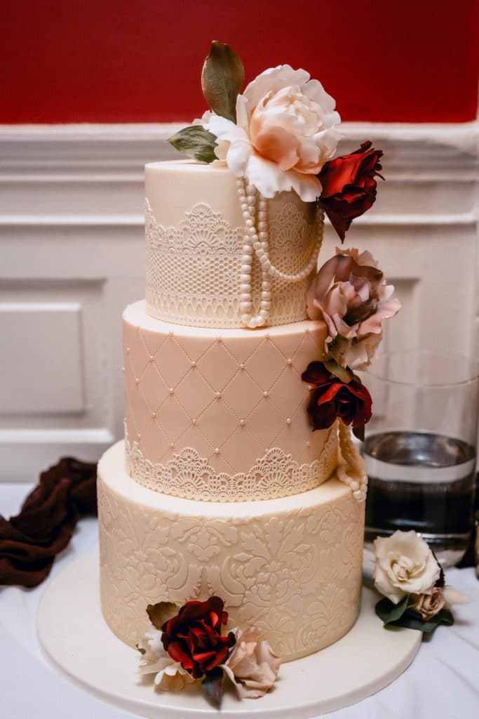 White and Blush Vintage Lace and Peal Three-Tier Cake. Photo by Cindy Lottes Photography