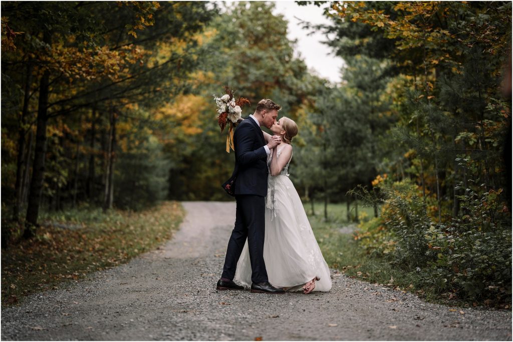Bride & Groom kiss in the laneway at Adelina Barn Venue in Gatineau Quebec