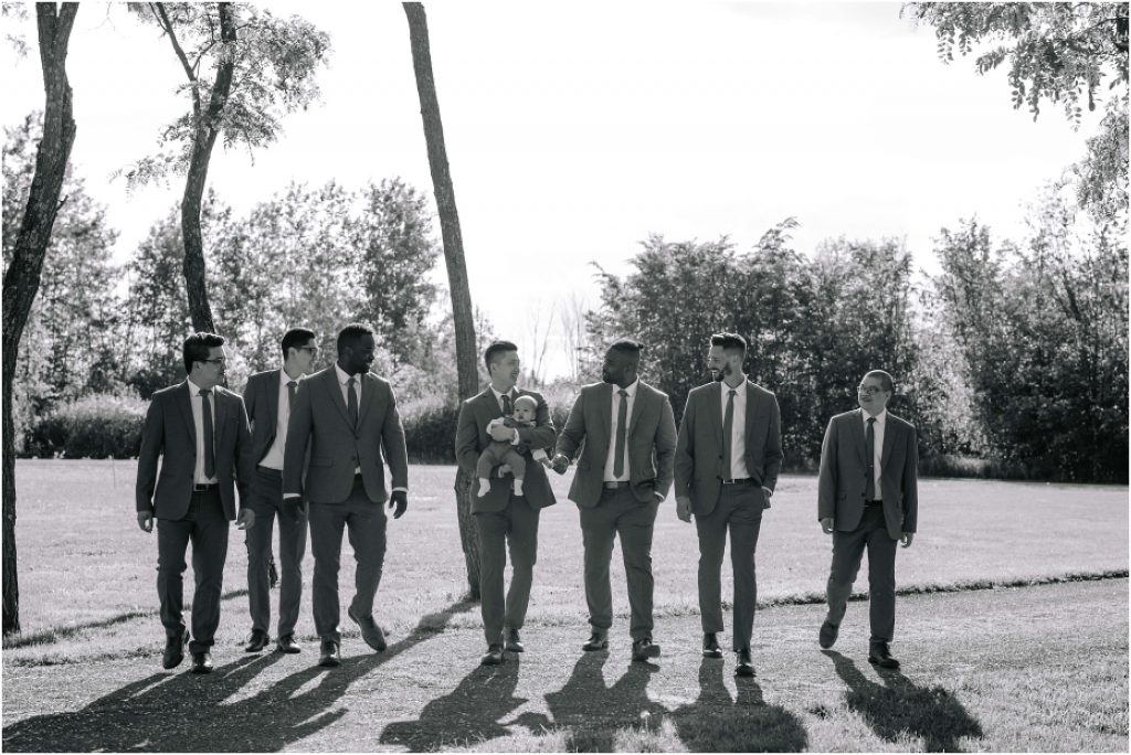 Groom and groomsmen posing for a walking photo at Stonefields Estate near Ottawa.