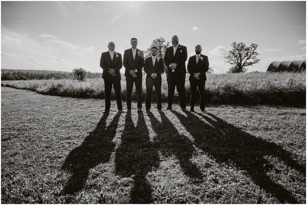 A black and white portrait of a groom with his groomsmen. Photo by Cindy Lottes Photography