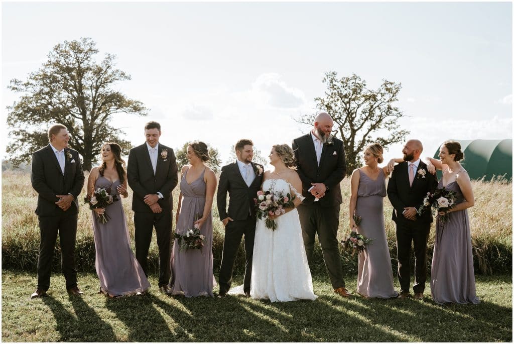 A wedding party laugh together after a wedding ceremony. Photo by Cindy Lottes Photography