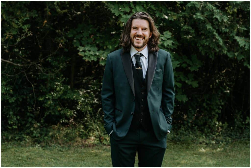 A groom smiles at his relaxed wedding in Perth, Ontario.